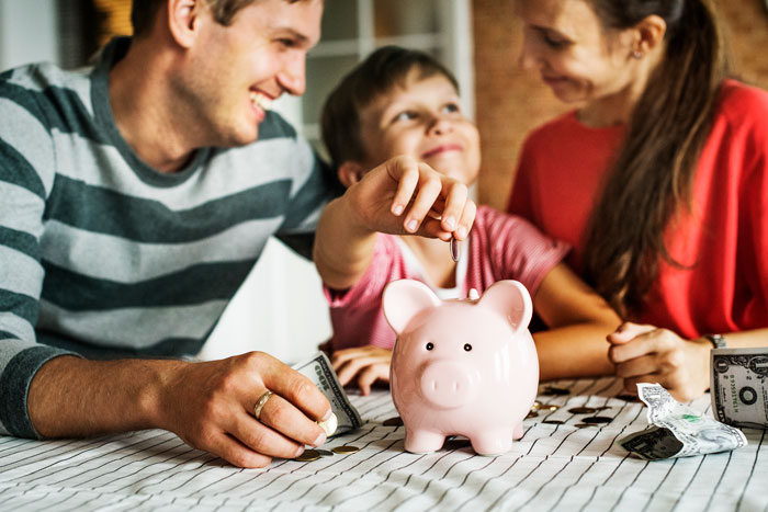 Family saving with a piggy bank
